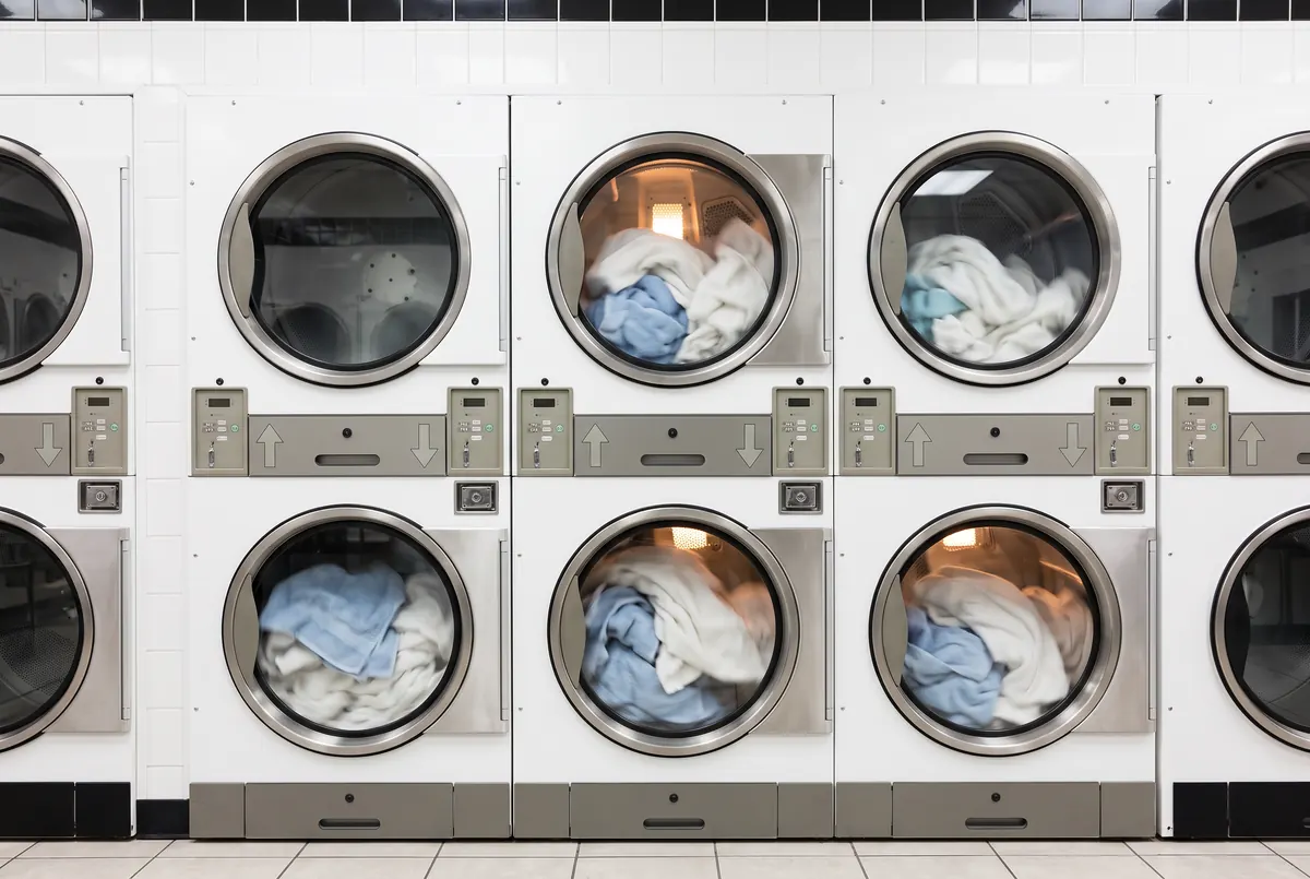 Towels tumbling in the stacked dryers at Smile Laundromat
